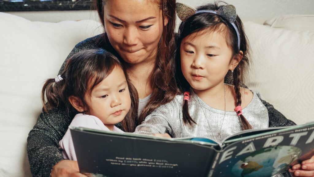 Mother reading to her two young daughters